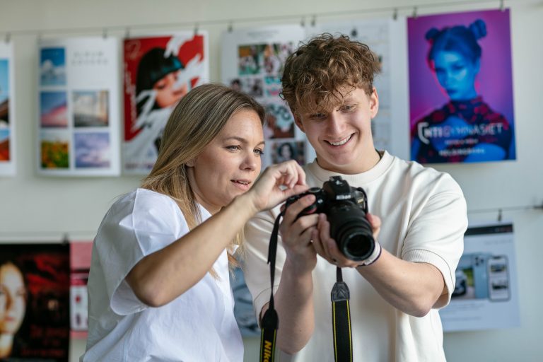 Lärare och en elev som håller i en kamera i vår mediesal Warhol.